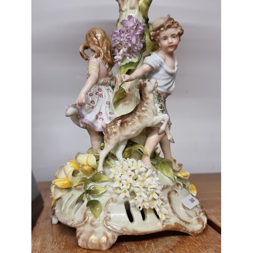 131 - Star Lot : An incredibly large and lavish vintage porcelain jardinière with a young boy and girl pla... 