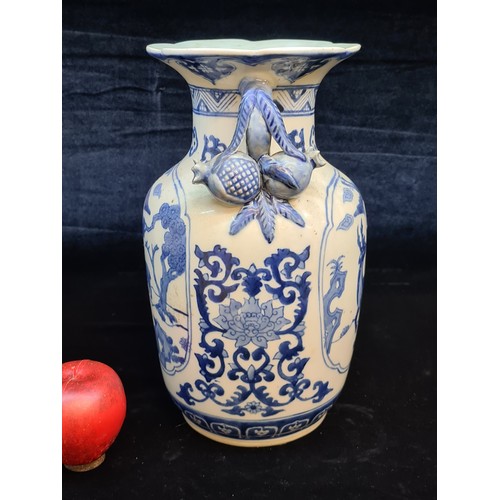 674 - A large and striking Chinese ceramic vase. Featuring large figural pomegranate handles and an unusua... 