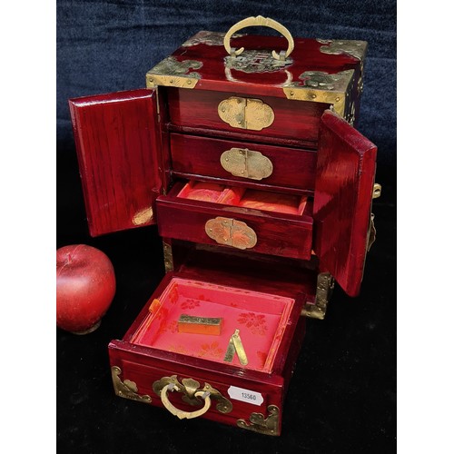 679 - A beautiful Chinese lacquered jewellery box. Finished in a rich red stain with etched brass hardware... 