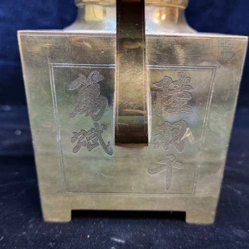 606 - A striking polished brass teapot with Chinese characters to side, and unusual square shape. There is... 