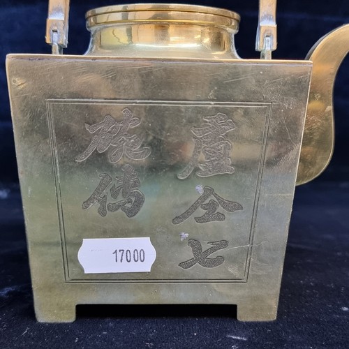 606 - A striking polished brass teapot with Chinese characters to side, and unusual square shape. There is... 