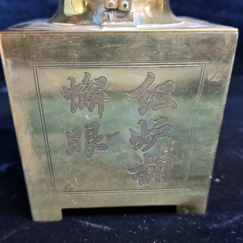 606 - A striking polished brass teapot with Chinese characters to side, and unusual square shape. There is... 