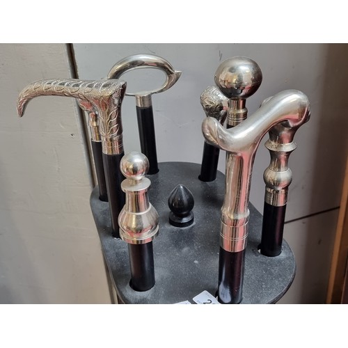 264 - Star Lot ; A nice quality walking stick stand with eight walking sticks within, each with silver ton... 