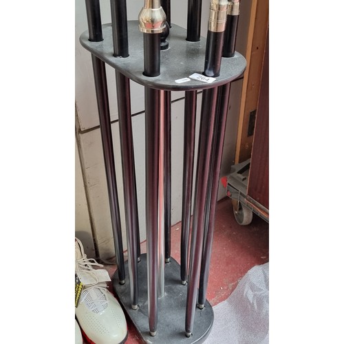 264 - Star Lot ; A nice quality walking stick stand with eight walking sticks within, each with silver ton... 