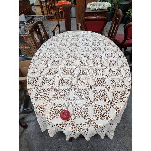 312 - A large vintage hand crocheted lace table cloth / throw featuring a rich floral motif throughout. An... 