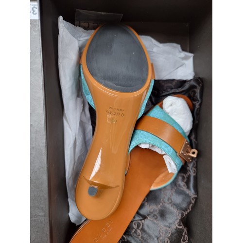 331 - STAR LOT : A pair of very stylish as new genuine Gucci heeled sandals with a turquoise strap featuri... 