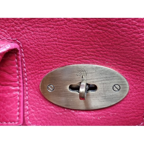 334 - Star lot : A beautiful genuine Mulberry ladies handbag in a hot pink shade with brass toned fittings... 