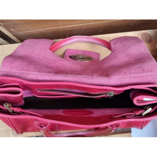 334 - Star lot : A beautiful genuine Mulberry ladies handbag in a hot pink shade with brass toned fittings... 