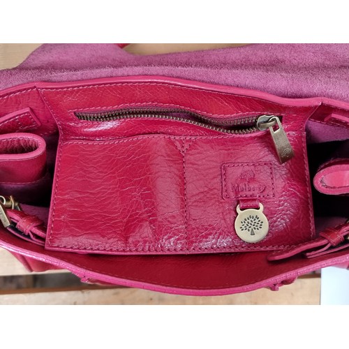 334 - Star lot : A beautiful genuine Mulberry ladies handbag in a hot pink shade with brass toned fittings... 