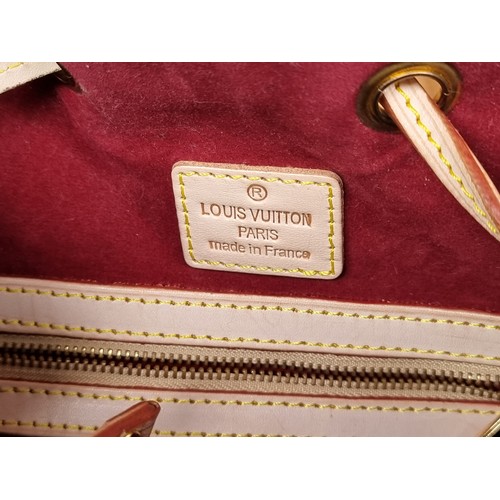 335 - Star lot : A genuine Louis Vuitton leather handbag featuring the iconic brand monogram in vibrant sh... 