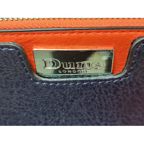 598 - A very striking New designer ladies' handbag by Dune in the Domino style. Designed in a navy blue ge... 