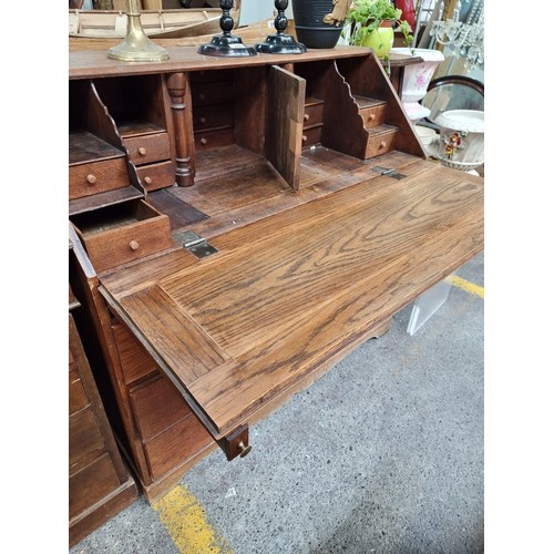 499 - A wonderful mid century  writing bureau with hinged desk that lowers to reveal eight neatly proporti... 