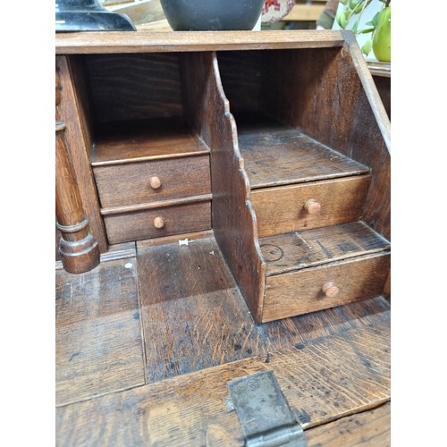 499 - A wonderful mid century  writing bureau with hinged desk that lowers to reveal eight neatly proporti... 