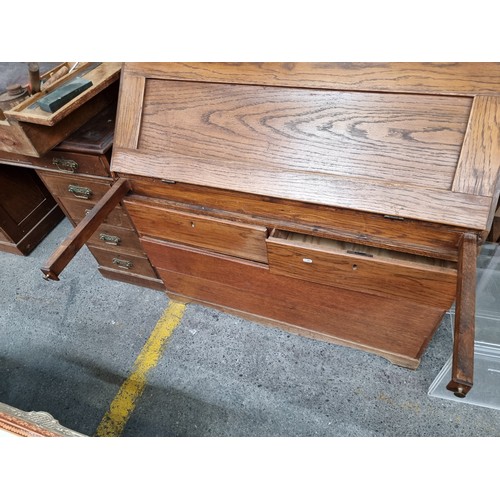 499 - A wonderful mid century  writing bureau with hinged desk that lowers to reveal eight neatly proporti... 