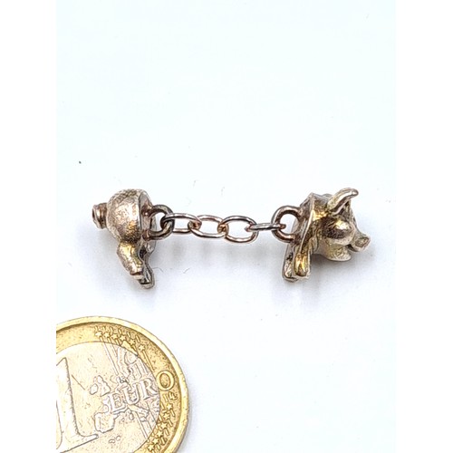 6 - A beautiful and intricate pair of sterling silver cuff links, featuring quirky piglets. Presented in... 