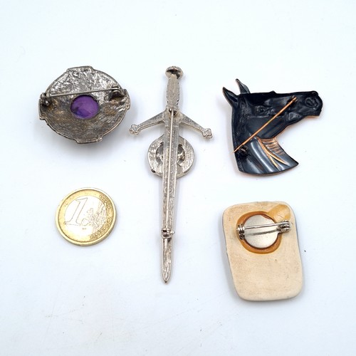15 - An excellent collection of four assorted brooches, featuring an unusual ceramic tiled example, A Sco... 