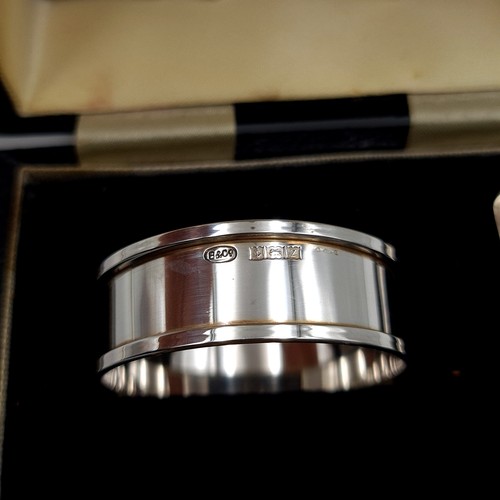 51 - A fabulous boxed silver collection, comprising of a sterling silver egg cup, spoon and napkin holder... 