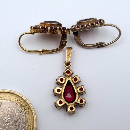 502 - An attractive 925 silver gilt Garnet suite, consisting of a pendant and a matching pair of Garnet cl... 