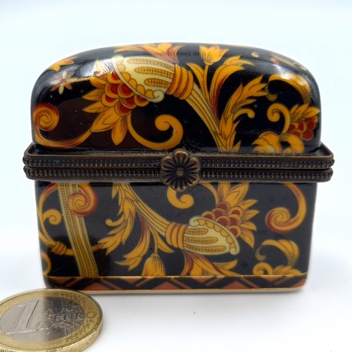 523 - A vintage French porcelain floral motif hinged casket, encased are three brass topped scent files. L... 