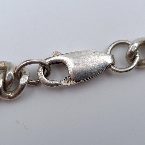 528 - A sterling silver bracelet, set with a Lobster clasp. Weight: 16.38 grams. Encased in a gift box.