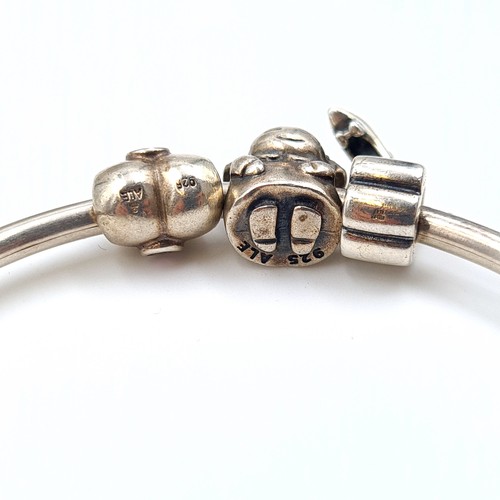 541 - A designer Sterling Silver Pandora charm bracelet, set with three pretty charms. Dimensions: 6cm. We... 