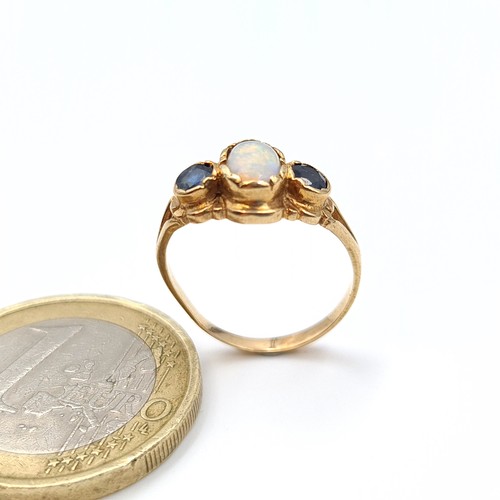 548 - An attractive 9 carat gold childs ring, featuring a beautiful central Fire Opal and Sapphire stones.... 