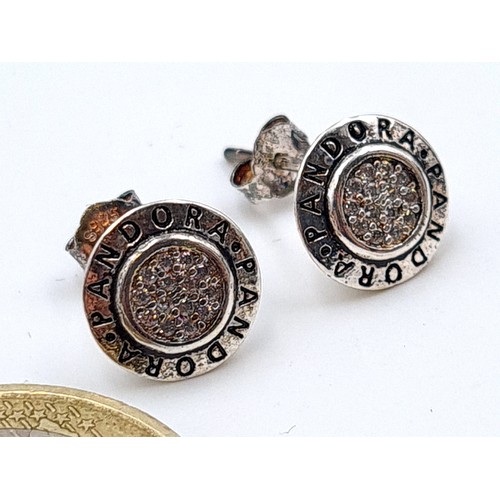 556 - A pair of designer Pandora stud earrings. In as new condition and encased in original gift box.