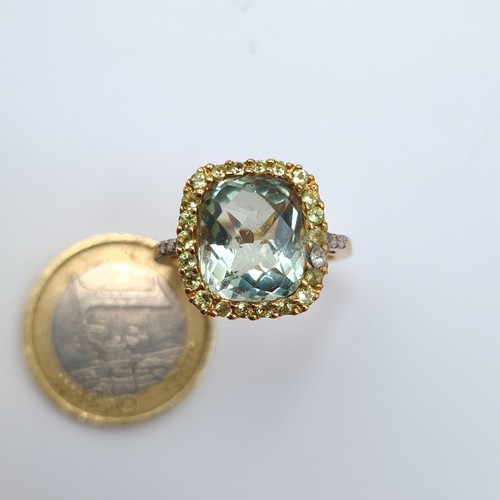 568 - Star Lot: A fabulous  vintage Green Topaz 9 carat gold ring, featuring an intricate Diamond surround... 