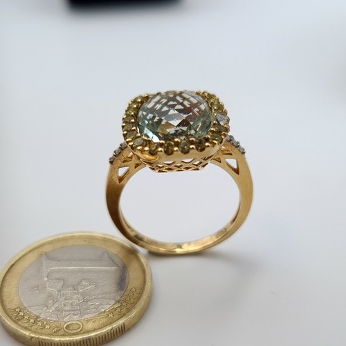 568 - Star Lot: A fabulous  vintage Green Topaz 9 carat gold ring, featuring an intricate Diamond surround... 