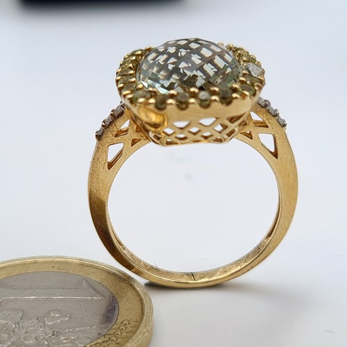 568 - Star Lot: A fabulous  vintage Green Topaz 9 carat gold ring, featuring an intricate Diamond surround... 