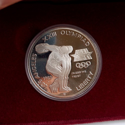 575 - Two United States one dollar Olympic silver coins, relating to the 1984 Olympiad. Encased in its ori... 