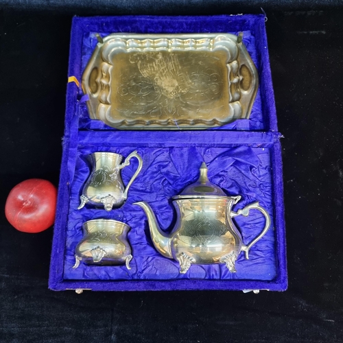 109 - A charming four piece vintage serving set in a brass toned metal. Housed in a purple velvet lined bo... 