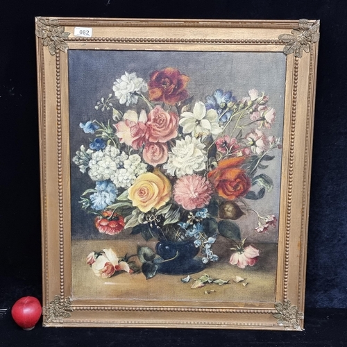 82 - Star lot : A brilliant original oil on canvas painting showing a bountiful bouquet of flowers held i... 