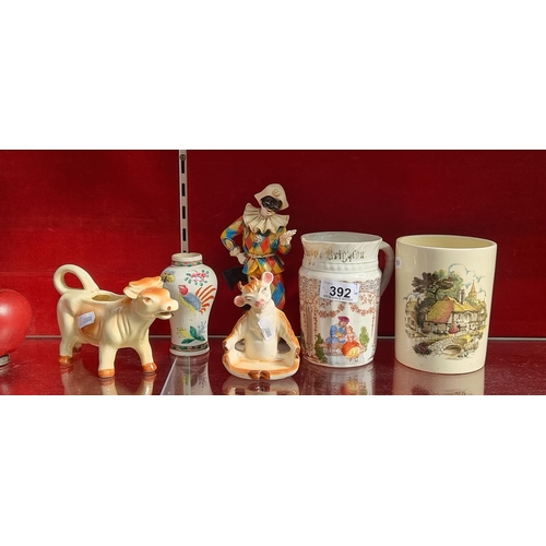 392 - Six items including a German made pitcher featuring courting scenes, two charming ceramic cow figure... 