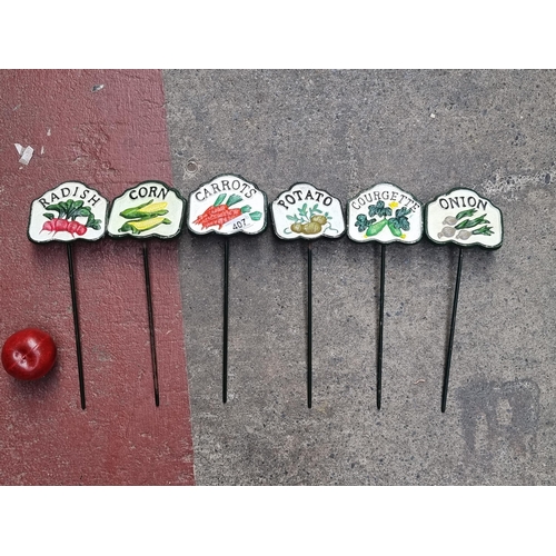 407 - Six cast metal vegetable markers including corn, carrots and onion. Perfect for any garden.