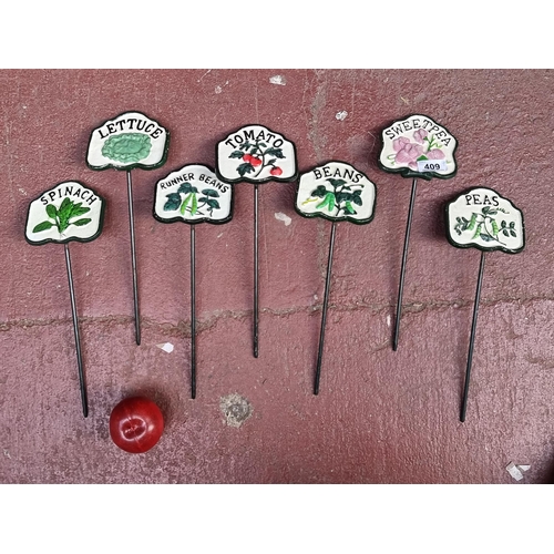 409 - Seven cast metal vegetable markers including spinach, peas and beans. Great for any garden.