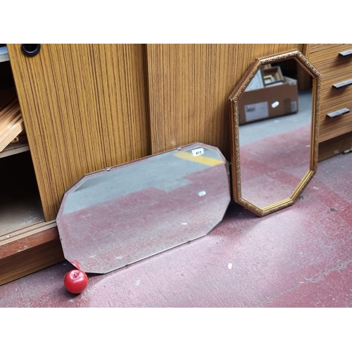 411 - Two vintage wall mirrors in a hexagonal form including an example with bevelled glass and another wi... 