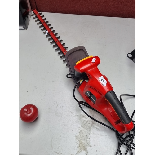 437 - A Homelite HHT400T hedge trimmer with a guard and a three-prong plug.