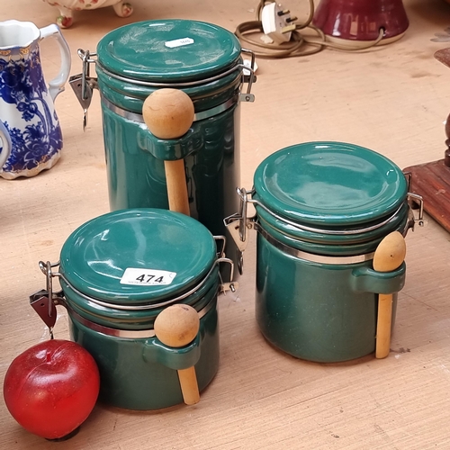 474 - A trio of high quality ceramic food storage jars. These are heavy examples in a dark green glaze. Wi... 