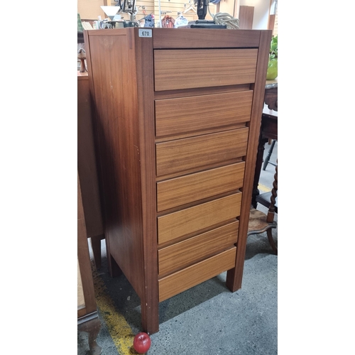 670 - A tall and stylish wooden storage cabinet made by Zenia House, with seven flush handled drawers to f... 