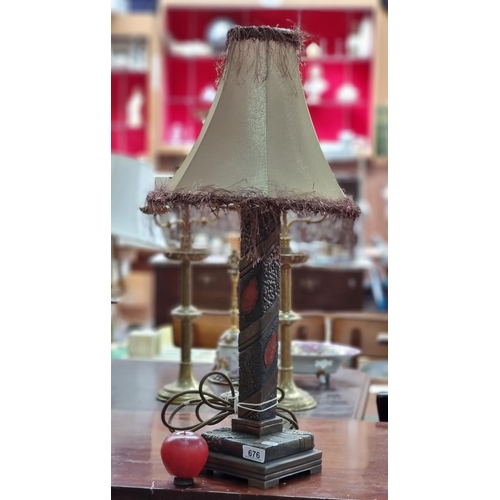 676 - An eyecatching and heavy bedside table lamp with a striking bronze toned stem with autumnal leaf mot... 