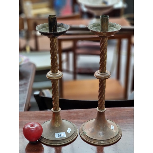 678 - A tall pair of 19th century church brass candlesticks with pie crust detailing to drip trays and rop... 