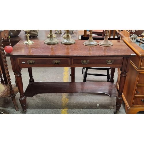 679 - A fabulous Edwardian console table with two pull drawers to front featuring brass drop handles with ... 