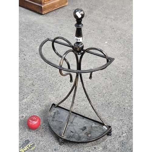 681 - A good example of a metal umbrella stand with scroll design and demi lune drip tray to base.