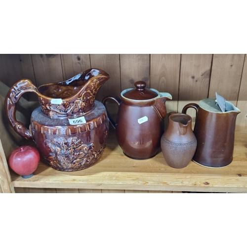 696 - Four vintage ceramic jugs including a Large example with relief design of lions playing in the under... 