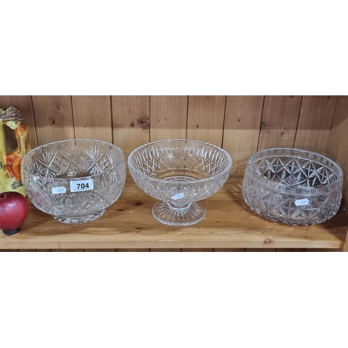 704 - Three cut crystal bowls including a taller footed example.