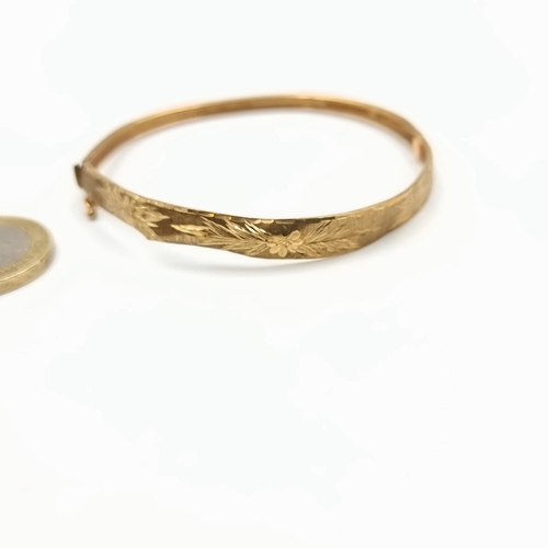 19 - A stunning and intricately formed antique 9 carat gold bangle, featuring an attractive hammered foli... 