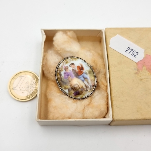 51 - An antique silver mounted porcelain brooch, depicting a late 18th century figero country courting sc... 