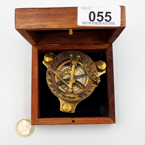 55 - A good brass compass with a built in sundial, set in wooden presentation box which features nautical... 