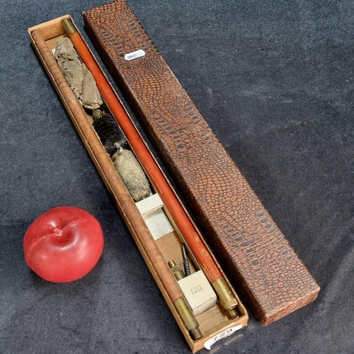 729 - A vintage gun cleaning set in original box with cleaning rod and soft and wire brushes.